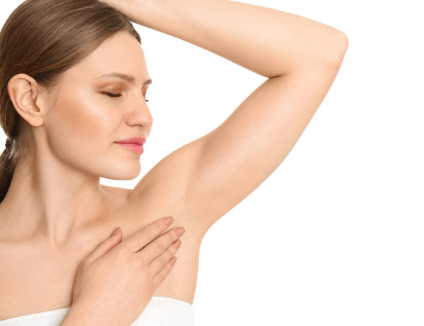 Young beautiful woman showing armpit with smooth clean skin on white background - Фото, зображення