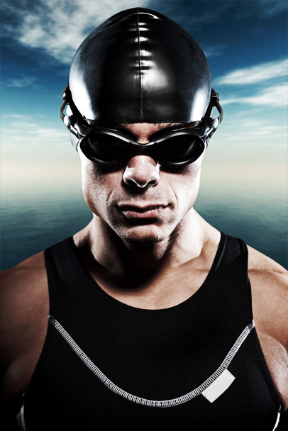 Triathlon swimmer man with cap and glasses outdoor at sea with b - Photo, Image