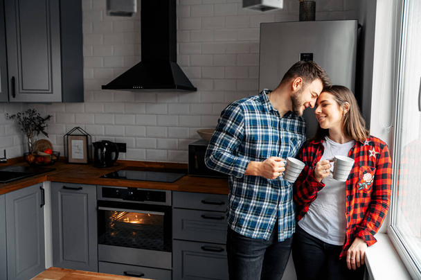 Couple in love in checkered shirts at home - Photo, image