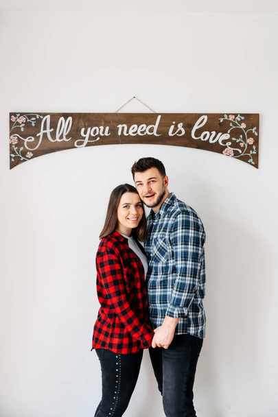 Loving couple under a wooden arch on a white background - Photo, image
