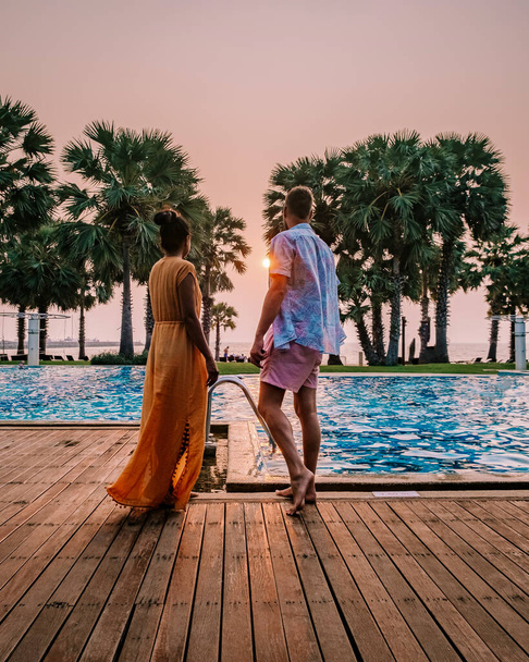 couple in swimming pool during a luxury vacation in Thailand, men and woman at luxury hotel resort in Thailand holiday in Asia - Fotografie, Obrázek