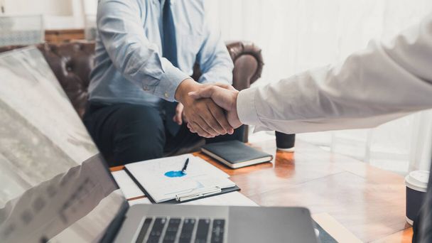 Business Meeting agreement Handshake concept, Hand holding after finishing up dealing project or bargain success at negotiation over office background. - Фото, зображення