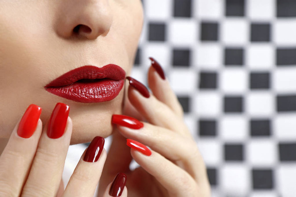 Red fashionable makeup and manicure on long square nails. Creative nail art. - Φωτογραφία, εικόνα
