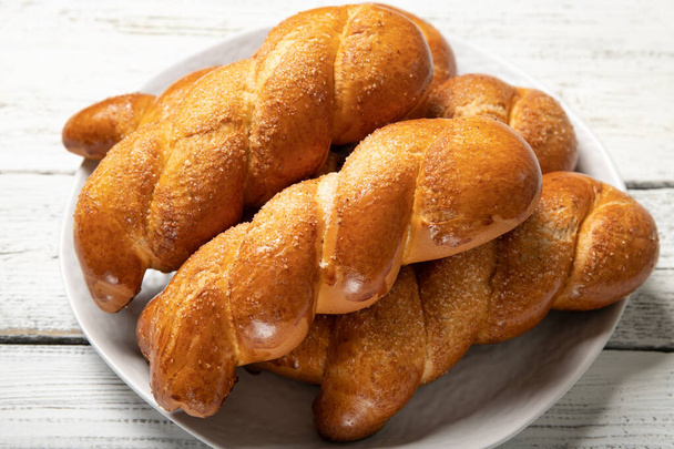 Delicious pastries.Tasty buns.Delicious Pigtail Buns.Close-up - Photo, Image