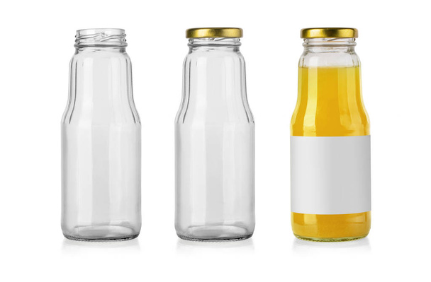 empty glass bottle and with juice isolated on white - Φωτογραφία, εικόνα