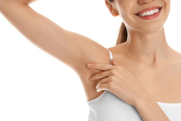 Young woman showing armpit with smooth clean skin on white background, closeup - Fotoğraf, Görsel