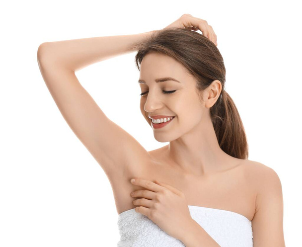 Young woman showing armpit with smooth clean skin on white background - Photo, Image