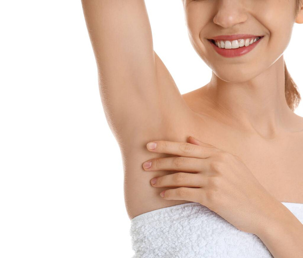 Young woman showing armpit with smooth clean skin on white background, closeup - Foto, Imagen