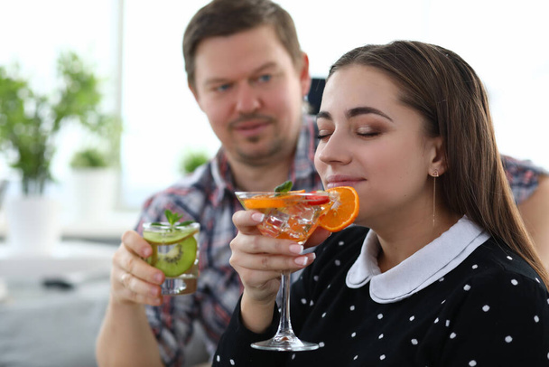 Man and girl drink alcoholic cocktails with fruits - Valokuva, kuva