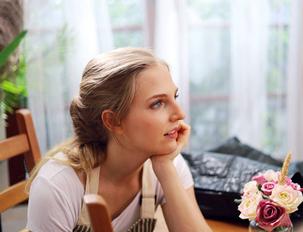 Beautiful young woman is preparing to cooking in kitchen room. - 写真・画像
