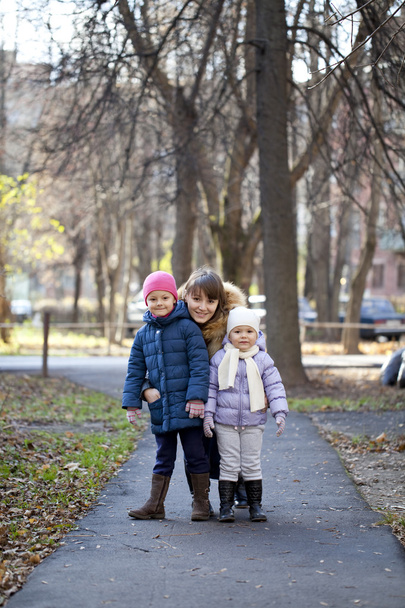Mother and her little girls outdoors session - Фото, изображение