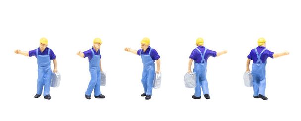 Miniature figurine character as railway track worker posing in posture isolated on white background. - Photo, Image