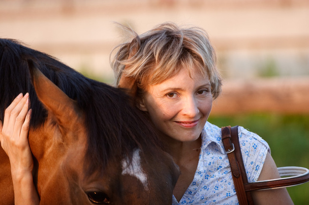 Woman embrace brown horse - Photo, image