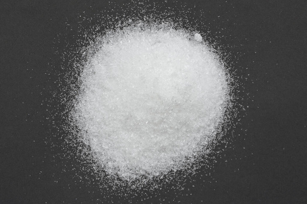 pile of monosodium glutamate isolated on black background - Photo, Image