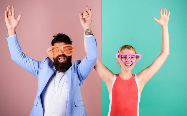 Couple having fun. Office party. Corporate culture. Diving into celebration. Playful businessman and colleague celebrating. Celebrating holiday. Bearded man pretty woman party goggles celebrating - 写真・画像