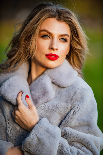 breezy and stylish. the best luxury clothing material. lady looking trendy walk in street. comfortable and warm. complement your outfit. modern winter fur coat. elegant woman red lips wear fur coat - Foto, imagen