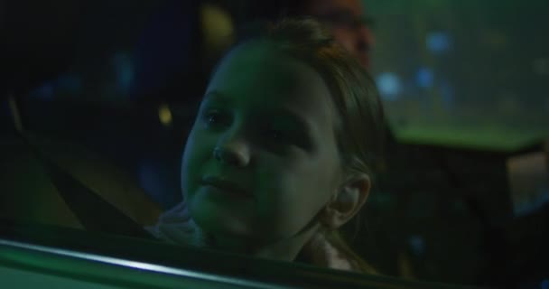 Girl watching and waving from car window - Felvétel, videó