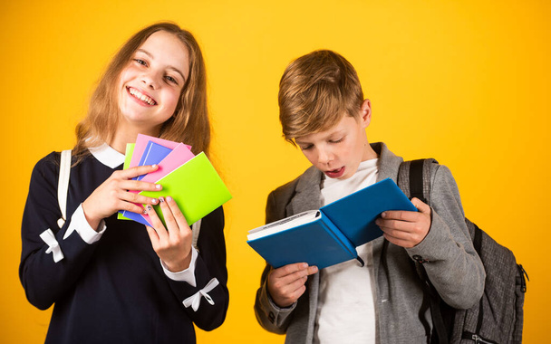 Exercise books ready for school ahead. Small children hold note books. Little girl and boy with activity books. Preparing books for studying. Private lesson. Education and study - Zdjęcie, obraz