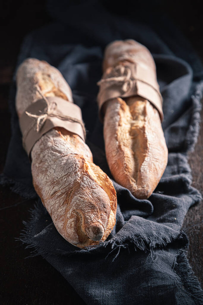 Closeup of french baguettes on dark table - Fotó, kép