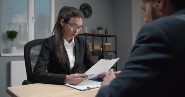 Lady in formal clothing reading resume of new employee - Video, Çekim
