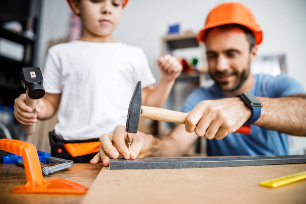 Happy father and son working with nails stock photo - Foto, Bild