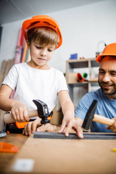 Smiling parent and kid using hand tools stock photo - Foto, afbeelding