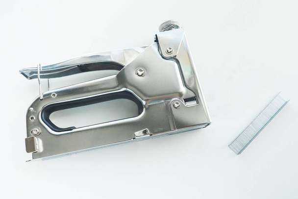 metal construction stapler and staples for it on a white background. Isolat - Photo, Image