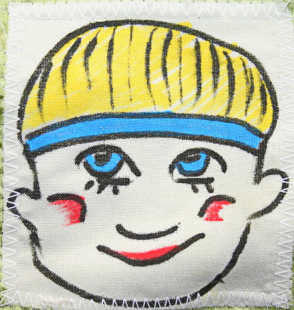 dibujo con plumas de fieltro en una cara textil con ojos azules y una sonrisa
 - Foto, Imagen