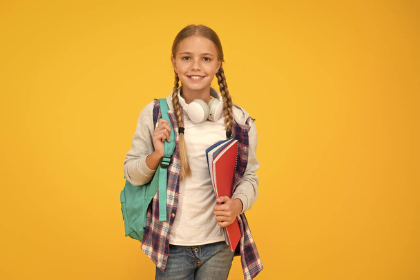 Motivated and diligent. Stylish schoolgirl. Girl little fashionable schoolgirl carry backpack. Schoolgirl daily life. School club. Modern education. Private schooling. Teen with backpack and books - Fotó, kép