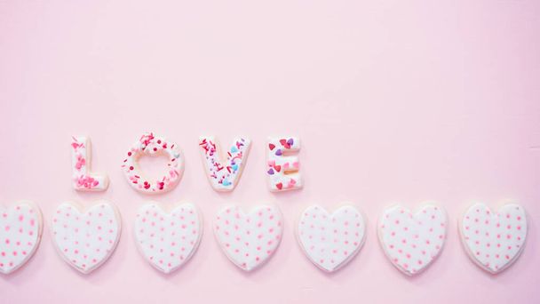 Flat lay. Valentine's Day LOVE sign on a pink background. - Foto, imagen