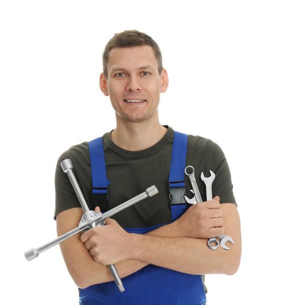 Portrait of professional auto mechanic with wrenches on white background - Zdjęcie, obraz