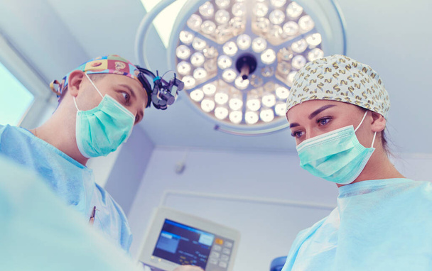 Man surgeon at work in operating room - Фото, зображення
