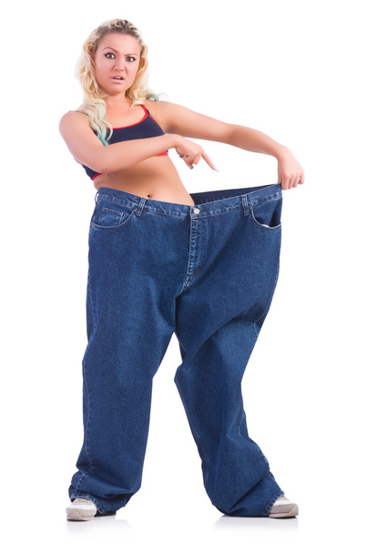 Woman in dieting concept with big jeans - 写真・画像