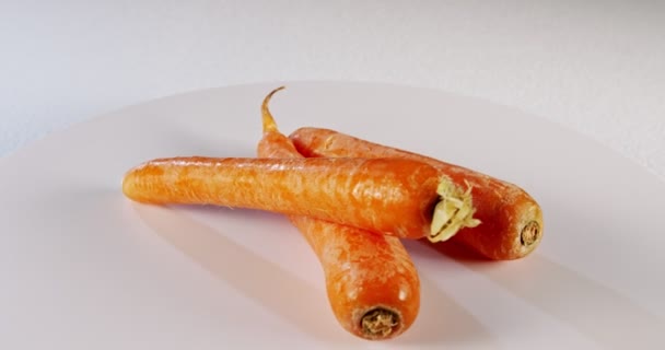 Zanahorias girando sobre fondo blanco
 - Metraje, vídeo