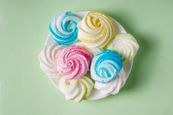 Homemade sweet colored meringue on white background.  - Foto, imagen
