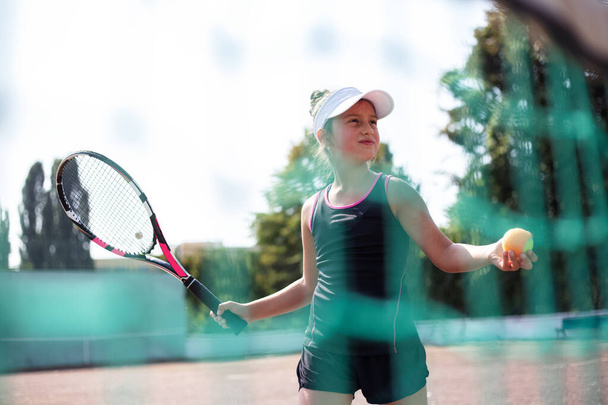 Portrait of teenage girl playing tennis on sport court. - Photo, Image