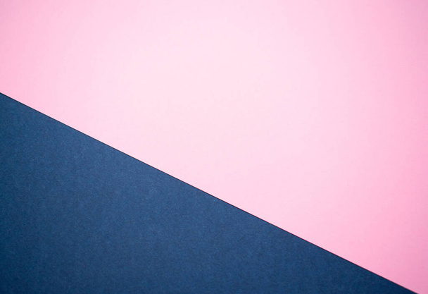 Soft pink and denim blue cardboard background, forming a diagonal line from left to right. - Photo, Image