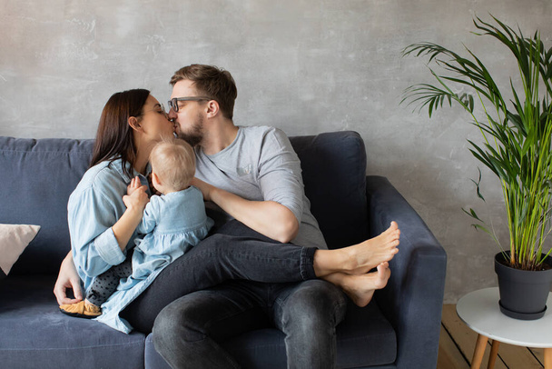 Young Family Playing Together on the Sofa. happy family. home comfort. - Foto, Imagen