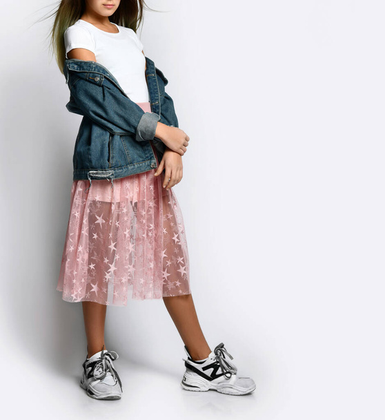 cropped photo of girl in stylish casual clothes, sneakers and pink sunglasses standing and looking at camera - Foto, Imagem