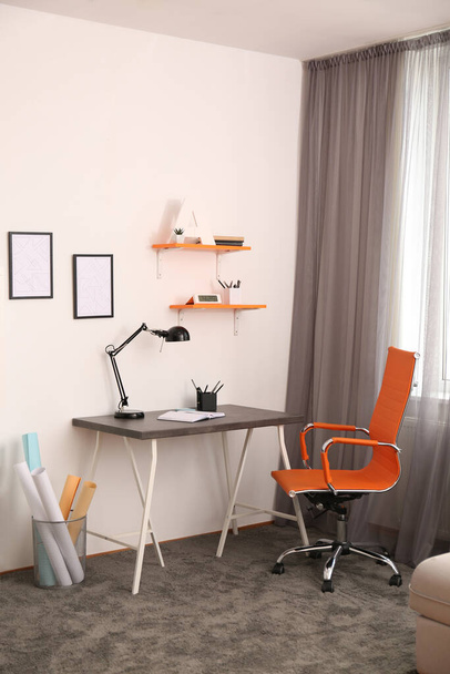 Stylish room interior with comfortable workplace near window. Design idea - Valokuva, kuva