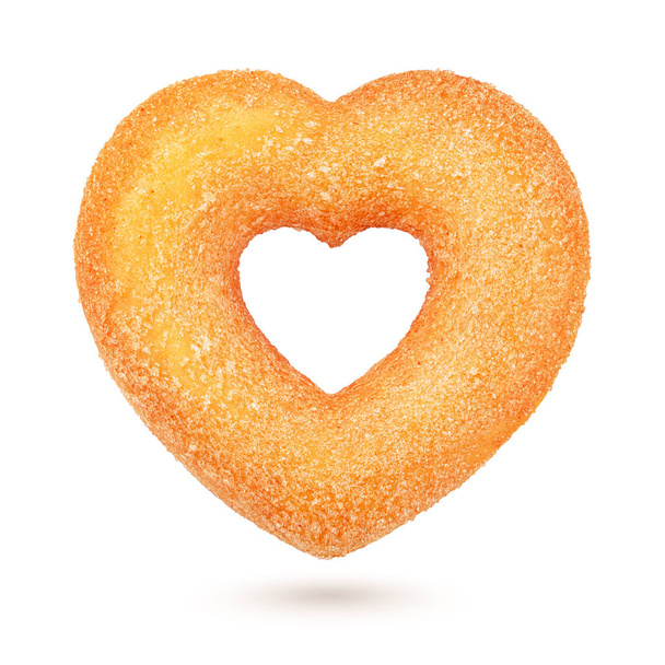 Желтый пончик в форме сердца с сахарной крошкой на белом фоне
 - Фото, изображение