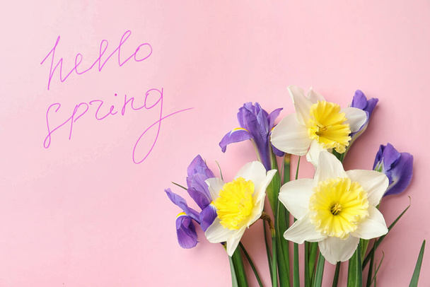 Words HELLO SPRING and fresh flowers on pink background, flat lay - Foto, Imagen