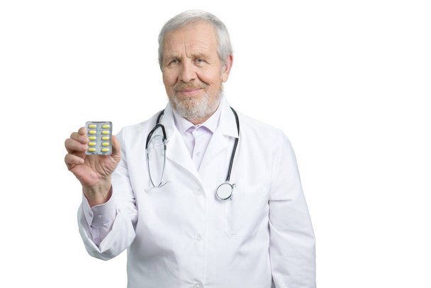 Old doctor with pack of pills. - Photo, Image