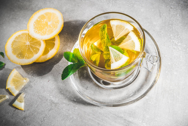 Teacup of mint tea leaves in a cup with fresh slice lemon isolated on gray Top view - Above - Foto, immagini