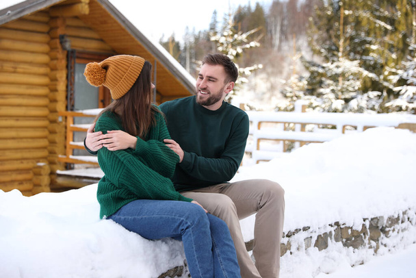 Lovely couple spending time together on snowy day. Winter vacation - Foto, Bild