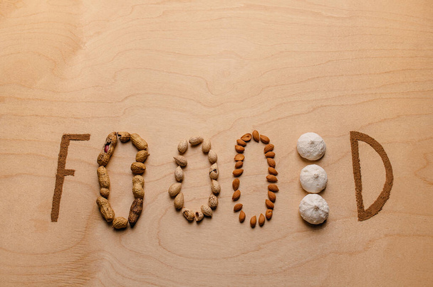 Creative bright writing on the table made from nuts and cinnamon - Fotó, kép