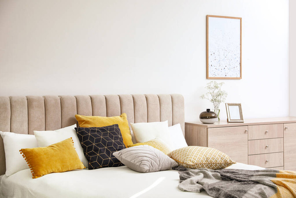 Comfortable bed with soft pillows in stylish room interior - Φωτογραφία, εικόνα