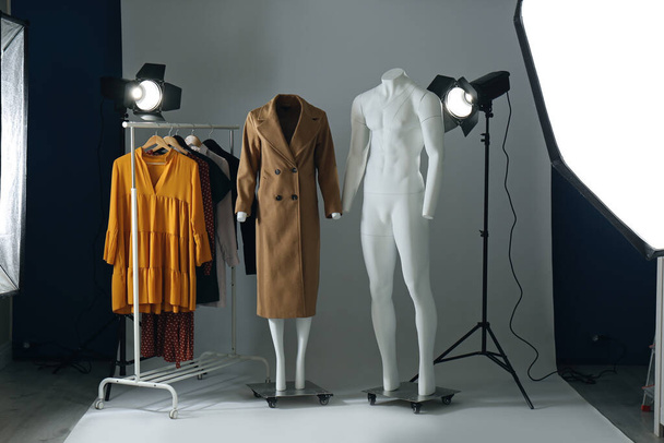 Ghost mannequins, clothes and professional lighting equipment in modern photo studio - Fotoğraf, Görsel