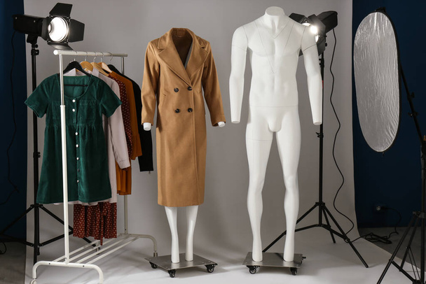 Ghost mannequins, clothes and professional lighting equipment in modern photo studio - Фото, зображення