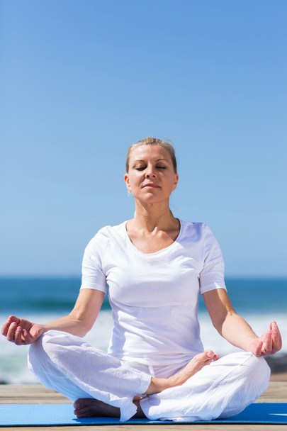 mid age woman meditating - Foto, imagen